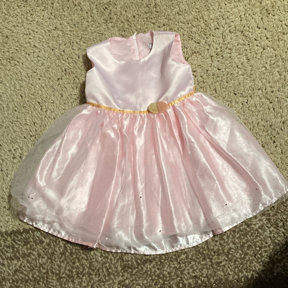 Dorissa sparkle tulle pink dress with a gold tie.